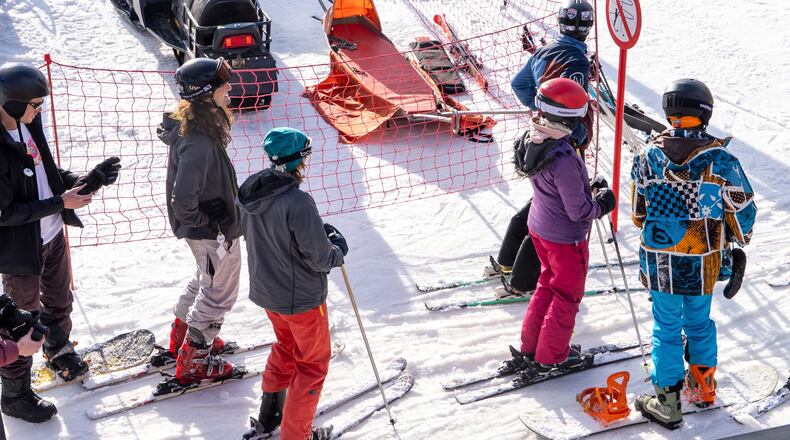 A group of skiers gather on the slopes at Afriski Mountain Resort in Maluti, Lesotho, Saturday, July 11, 2026. (AP Photo/Kayleen Morgan)