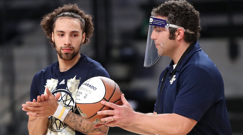 Georgia Tech head coach Josh Pastner presents guard Jose Alvarado a basketball recognizing him as a member of the 1,000 point club in a pregame ceremony before playing Clemson Tuesday, Jan. 20, 2021, in Atlanta. (Curtis Compton / Curtis.Compton@ajc.com)
