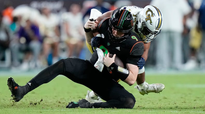 Georgia Tech linebacker Paul Moala sacks Miami quarterback Tyler Van Dyke during the second half of an NCAA college football game, Saturday, Oct. 7, 2023, in Miami Gardens, Fla. (AP Photo/Wilfredo Lee)