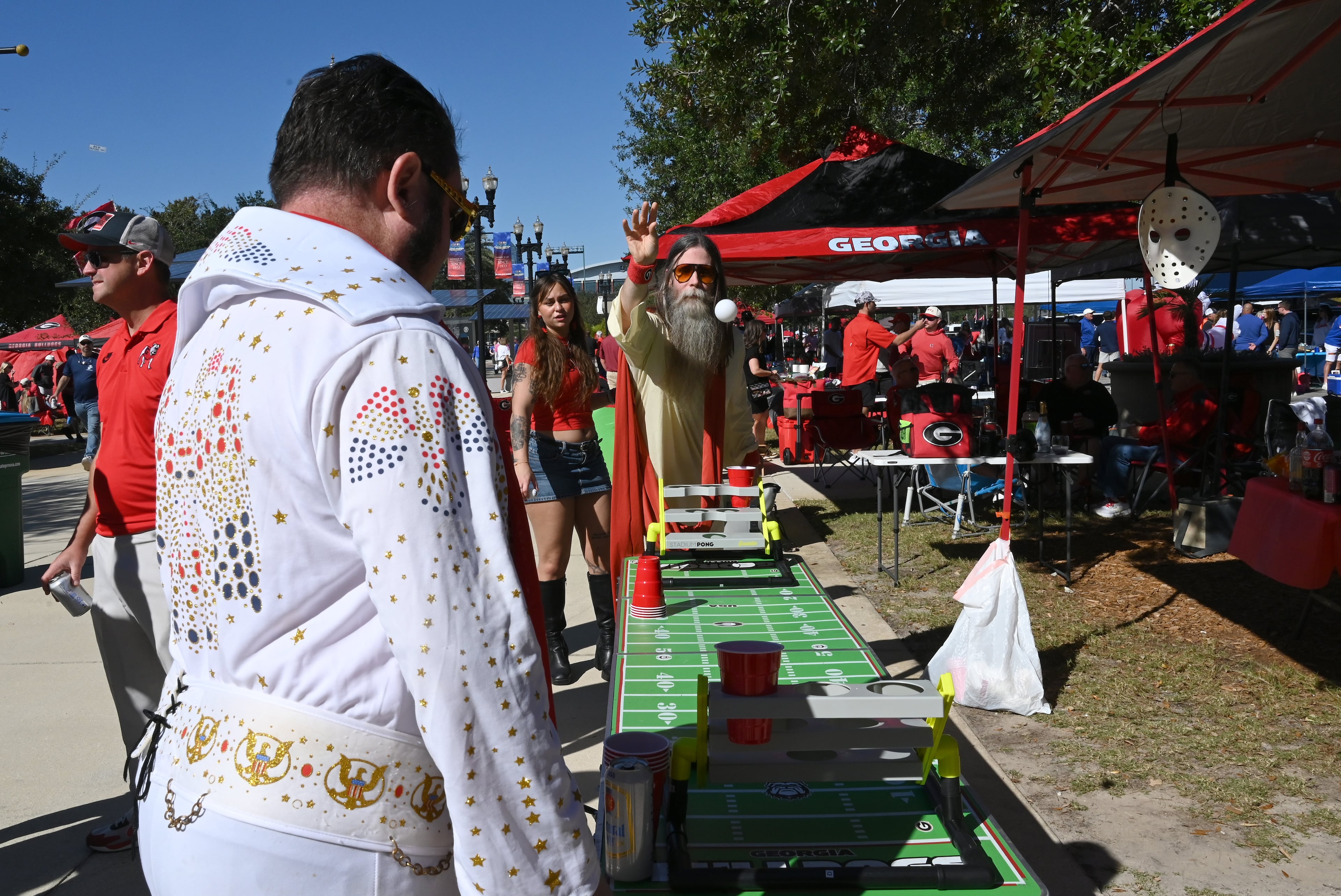 Jamie Jones (center) plays beer pong with other Georgia fans outside EverBank Stadium prior to an NCAA football game between Georgia and Florida, Saturday, Nov. 1, 2025, Jacksonville, Fla. (Hyosub Shin / AJC)