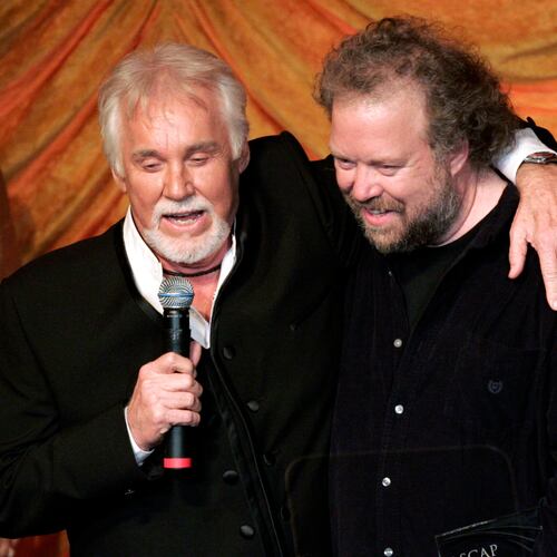 FILE - Kenny Rogers, left, presents the ASCAP Creative Achievement Award to songwriter Don Schlitz at the ASCAP Country Music Awards in Nashville, Tenn., Monday, Oct. 15, 2007. (AP Photo/Mark Humphrey, File)