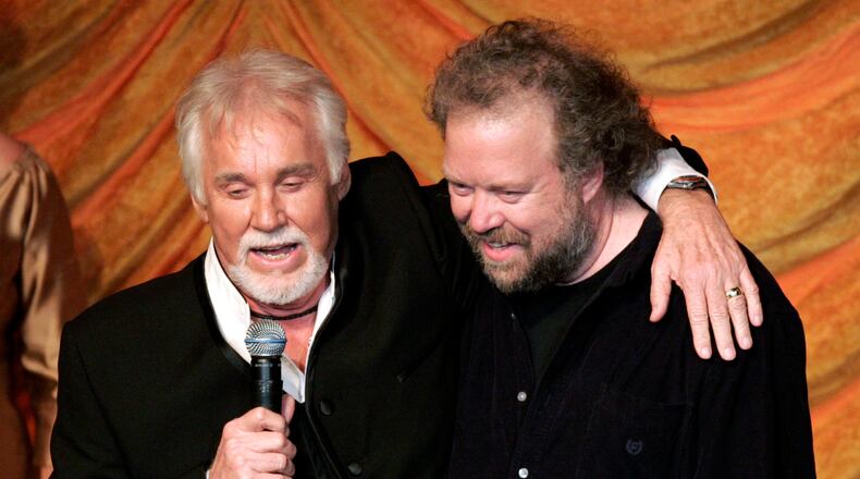 FILE - Kenny Rogers, left, presents the ASCAP Creative Achievement Award to songwriter Don Schlitz at the ASCAP Country Music Awards in Nashville, Tenn., Monday, Oct. 15, 2007. (AP Photo/Mark Humphrey, File)