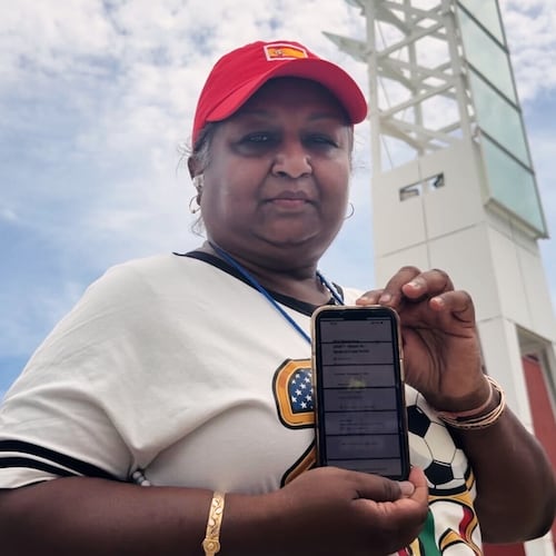 Bina Ramroop holds proof of the ticket she bought through StubHub for the World Cup Group H soccer match between Spain and Cape Verde in Atlanta on Monday, June 15, 2026. (AP Photo/Emilie Megnien)
