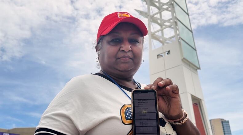Bina Ramroop holds proof of the ticket she bought through StubHub for the World Cup Group H soccer match between Spain and Cape Verde in Atlanta on Monday, June 15, 2026. (AP Photo/Emilie Megnien)