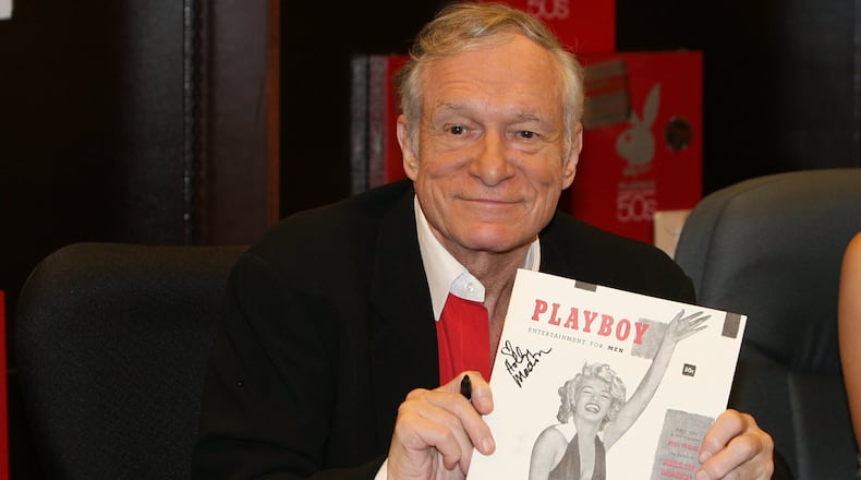 In this Nov. 15, 2007 photo, Hugh Hefner smiles while signing copies of the Playboy calendar and Playboy Cover To Cover: The 50’s DVD box set in Los Angeles. Playboy will no longer publish photos of nude women as part of a redesign of the decades-old magazine, according to a news report Monday, Oct. 12, 2015. Executives for the magazine company told The New York Times that the change will take place in March 2016. Playboy editor Cory Jones contacted founder and current editor in chief Hugh Hefner recently about dropping nude photos from the print edition and he agreed, the Times reported. (Ian West/PA via AP) UNITED KINGDOM OUT NO SALES NO ARCHIVE