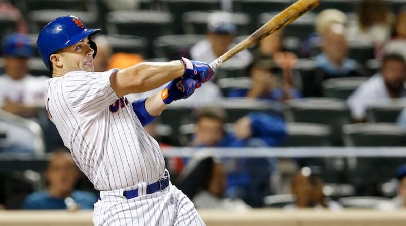 New York Mets' David Wright hits a seventh-inning, RBI, ground-rule double in a baseball game against the Miami Marlins in New York, Monday, Sept. 14, 2015. (AP Photo/Kathy Willens)