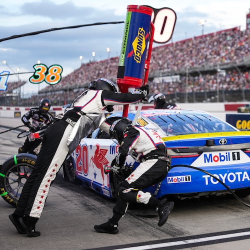 The pit crew for Christopher Bell rushes to complete a pit stop during a NASCAR Cup Series auto race at Darlington Raceway, Sunday, Sept. 6, 2026, in Darlington, S.C. (AP Photo/Matt Kelley)