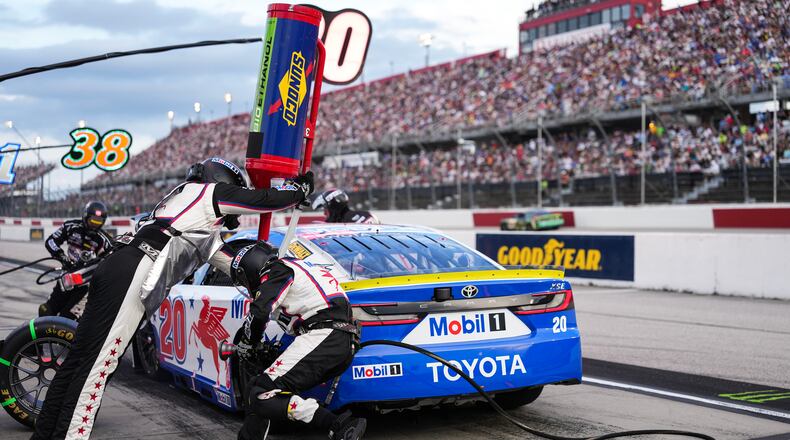 The pit crew for Christopher Bell rushes to complete a pit stop during a NASCAR Cup Series auto race at Darlington Raceway, Sunday, Sept. 6, 2026, in Darlington, S.C. (AP Photo/Matt Kelley)