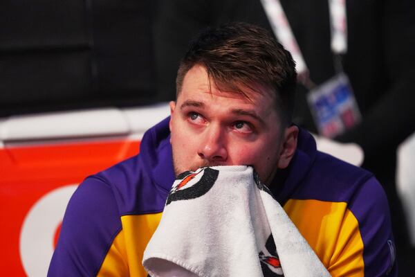 Los Angeles Lakers' Luka Doncic becomes emotional as he watches a video on the large video board that was a tribute to the former Dallas Mavericks player before an NBA basketball game in Dallas, Wednesday, April 9, 2025. (AP Photo/LM Otero)