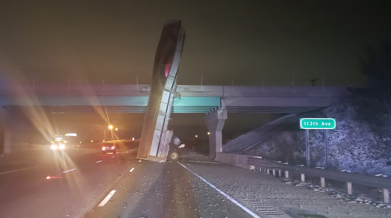 Indiana State Police said a “mishap” that led a trailer dump truck to become stuck on an overpass on Interstate 65 in Crown Point, Indiana