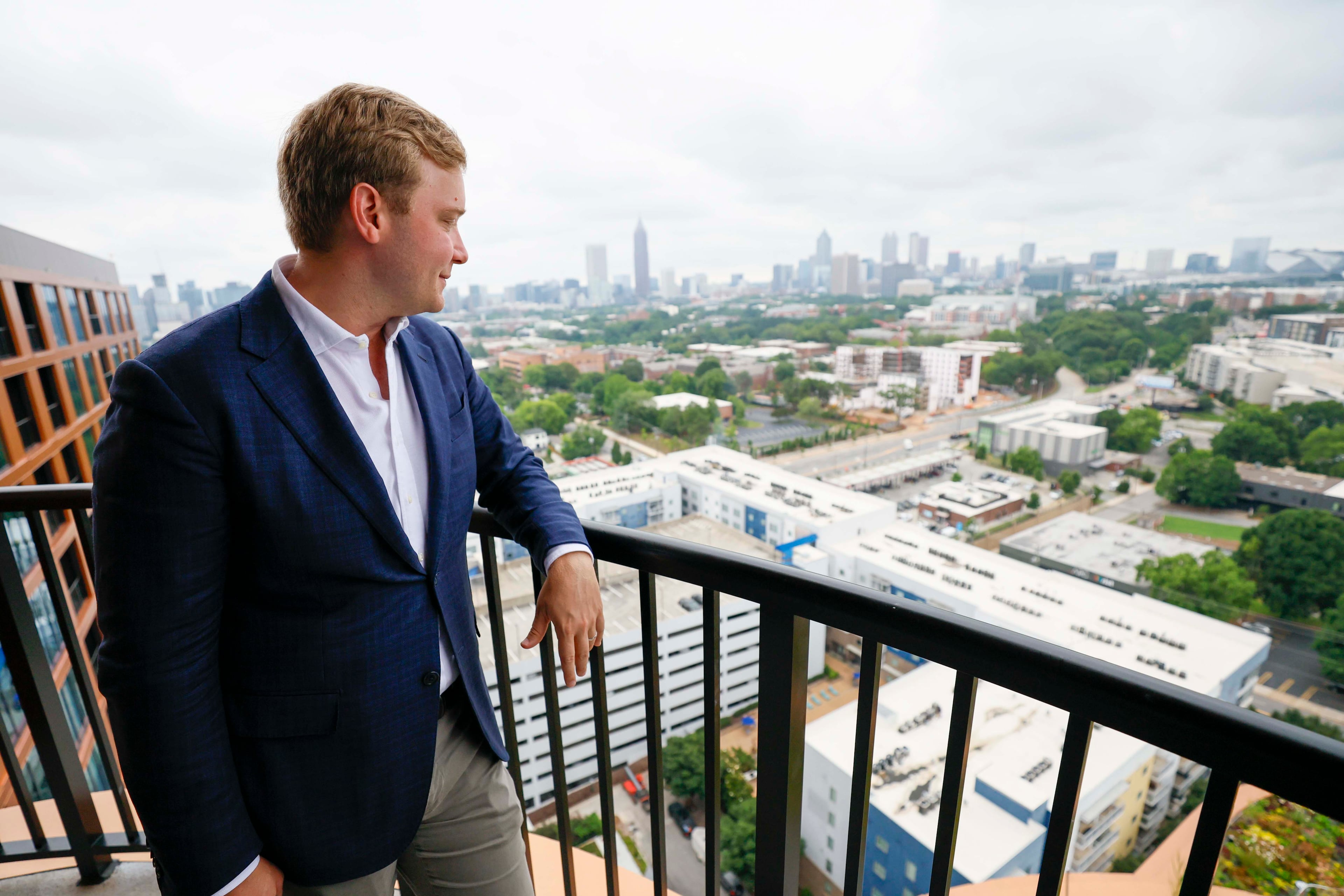 Spencer Morris, president of Allen Morris Co., enjoys the view from the 17th floor in one of the penthouses at Stella at Star Metals in West Midtown. (Miguel Martinez/ AJC)
