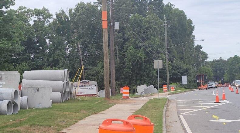 Construction is underway at Grogans Ferry and Roswell Road in Sandy Springs. Huge concrete cylinders currently resting on each side of the road are drainage pipes for the new storm drainage system.  (Courtesy City of Sandy Springs)