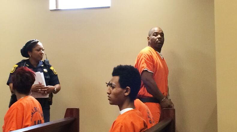 Charles Richey, standing at right, leaves court Thursday after a detective laid out the case against Richey, who is accused of murder in the death of a MARTA panhandler on a train.