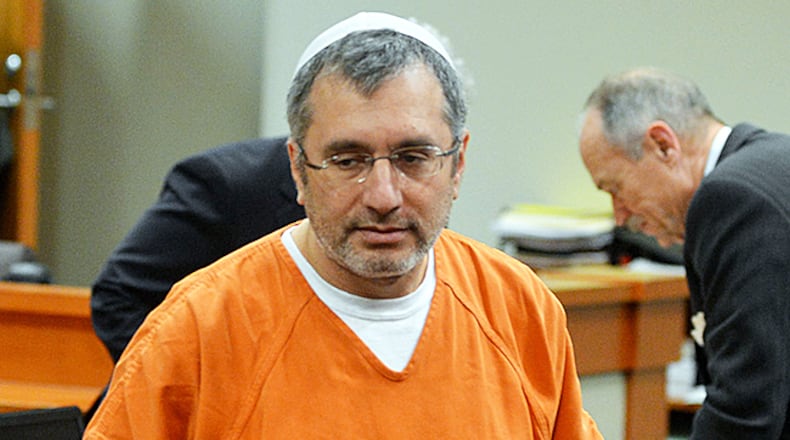 MARCH 4, 2014 DECATUR Convicted murderer Hemy Neuman leaves the courtroom after a hearing before Judge Gregory A Adams in Dekalb Superior Court Tuesday, March 4, 2014. Neuman's lawyers are seeking a new trial due in part to the perjury conviction of Andrea Sneiderman last year. Neuman was found guilty but mentally ill of shooting Rusty Sneiderman in front of a daycare in Dunwoody in November 2010. KENT D. JOHNSON / KDJOHNSON@AJC.COM