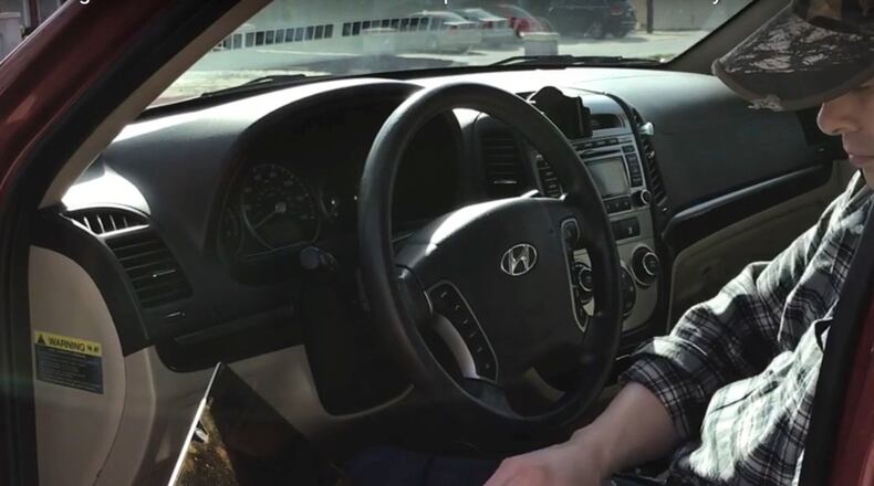 Raxis’ chief technology officer, Brian Tant, clones an entry badge. With a reader concealed in his backpack, he was able to steal information from an employee’s exposed badge and copy it to a blank. (Contributed)