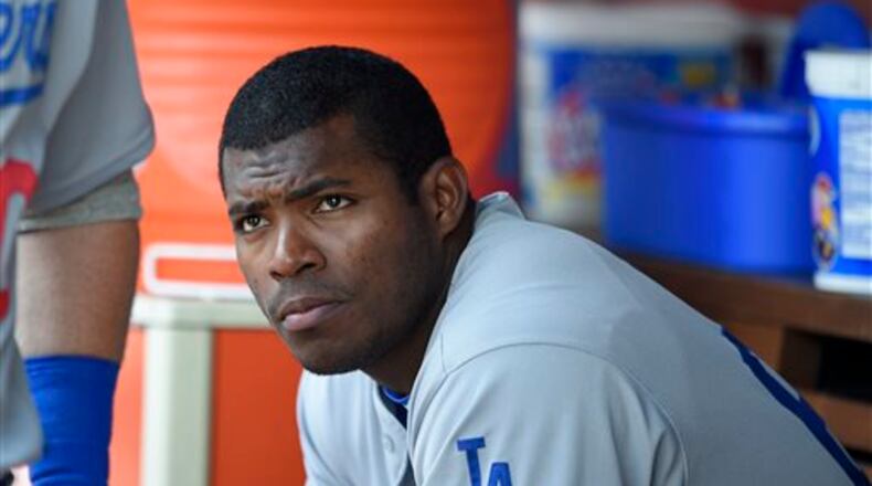 FILE - This July 21, 2016 file photo shows Los Angeles Dodgers' Yasiel Puig looking on from the dugout during a baseball game against the Washington Nationals in Washington. Puig's agent said Monday, Aug. 1, 2016 the Los Angeles Dodgers slugger expects to be sent to the minors after the club was unable to trade him at the deadline. (AP Photo/Nick Wass)