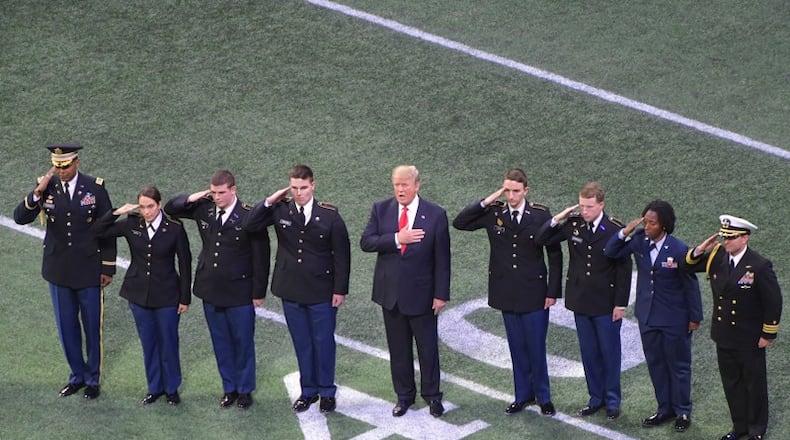 ROTC cadets from Georgia (left) and Alabama escorted President Trump onto the field at Mercedes-Benz Stadium. AJC photo: Hyosub Shin