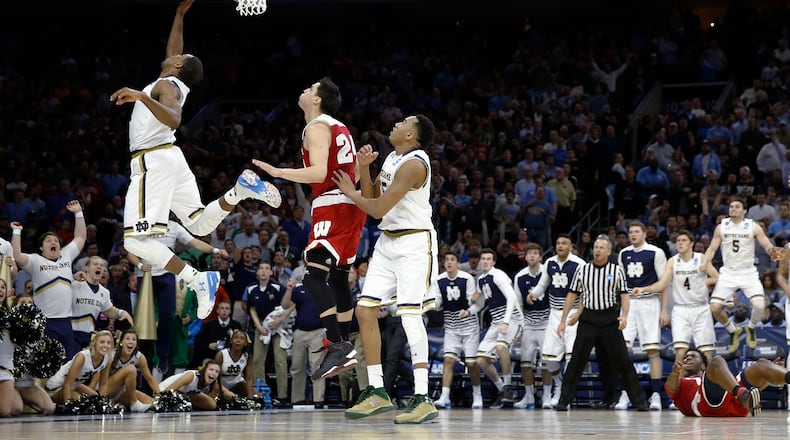 Notre Dame's Demetrius Jackson, left, goes up for a shot past Wisconsin's Bronson Koenig during the final minute of an NCAA college basketball game in the regional semifinals of the men's NCAA Tournament, Friday, March 25, 2016, in Philadelphia. Notre Dame won 61-56. (AP Photo/Chris Szagola)