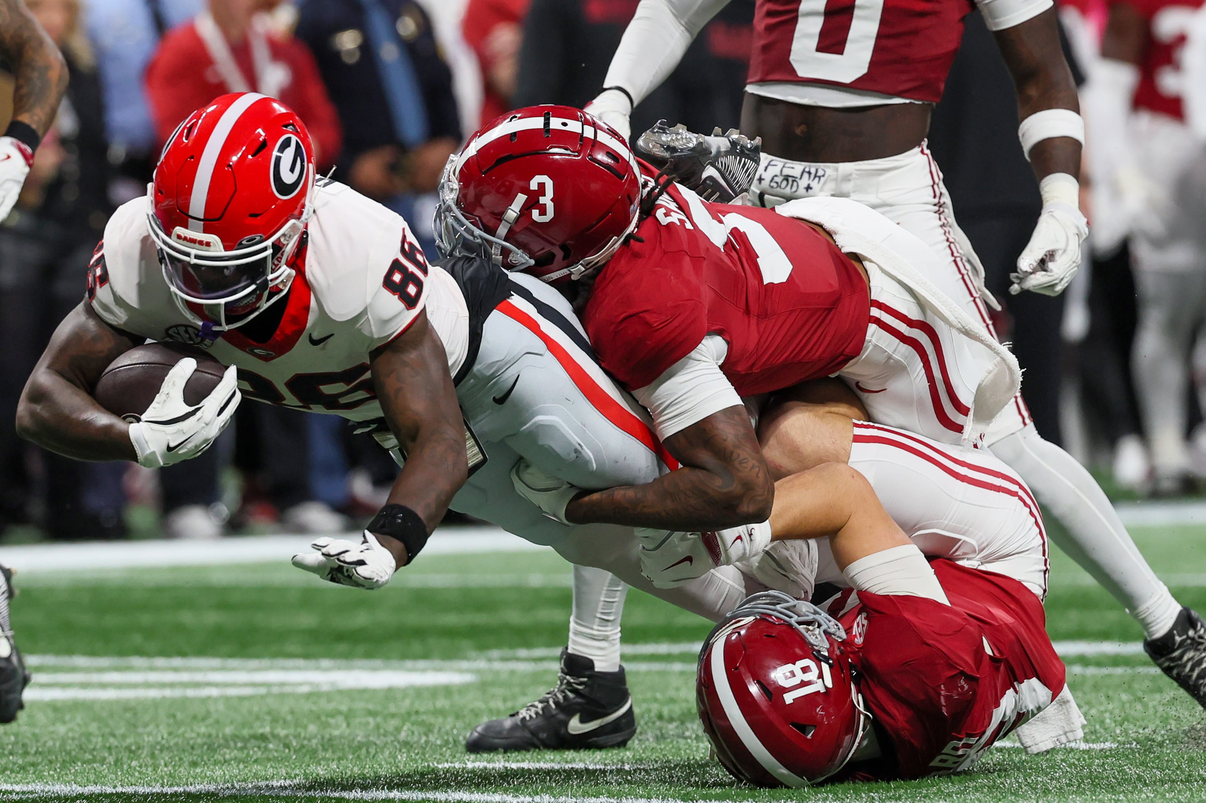 Georgia wide receiver Dillon Bell (86) is brought down by Alabama defensive back Keon Sabb (3) after a first down catch during the first half of the SEC Championship game at Mercedes-Benz Stadium, Saturday, Dec. 6, 2025, in Atlanta. (Jason Getz / AJC)