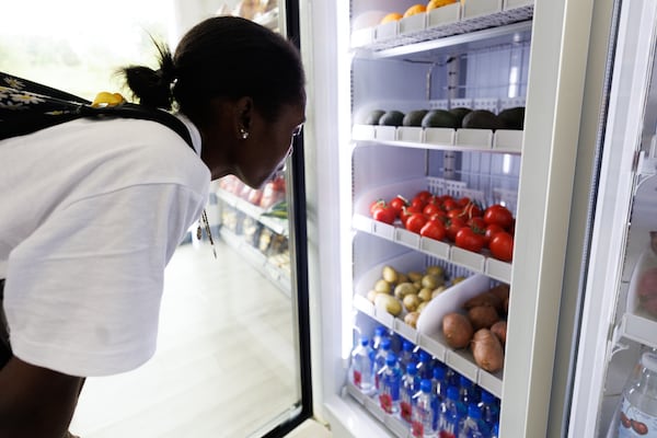 Miyah Daniels checks out the produce section of the newly opened Nourish + Bloom Market in Pittsburgh Yards in Atlanta on Thursday, June 25, 2026. (Estela Muñoz/AJC) 