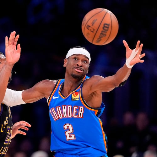 Oklahoma City Thunder guard Shai Gilgeous-Alexander, right, takes a pass while under pressure from Los Angeles Lakers forward Rui Hachimura during the first half of Game 4 in a second-round NBA basketball playoffs series Monday, May 11, 2026, in Los Angeles. (AP Photo/Mark J. Terrill)