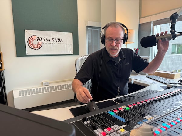 Loren Dixon, the director of programming at KNBA, the flagship station for National Native News and owned by Koahnic Broadcast Corp., is shown on air July 10, 2025, at the station's studios in Anchorage, Alaska. (AP Photo/Mark Thiessen)