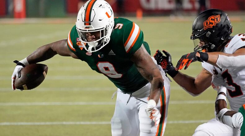 Miami tight end Brevin Jordan (9) makes a move to get by Oklahoma State safety Tre Sterling (3) during the second half of the Cheez-it Bowl Tuesday, Dec. 29, 2020, in Orlando, Fla. (John Raoux/AP)