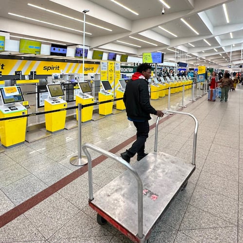 Spirit Airlines’ counter is passed by an airport employee after the airline’s shutdown on Saturday, May 2, 2026 at Hartsfield-Jackson Atlanta International Airport in Atlanta. (AP Photo/Jeff Amy)