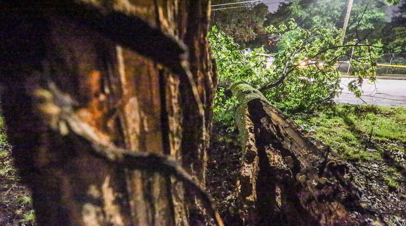 High winds in Tuesday night’s storms snapped a tree on Brewer Boulevard in Atlanta. JOHN SPINK / JSPINK@AJC.COM