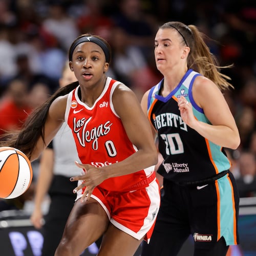 Las Vegas Aces guard Jackie Young (0) drives between New York Liberty center Jonquel Jones, left, and guard Sabrina Ionescu (20) during the first half of an WNBA basketball game Thursday, July 30, 2026, in Las Vegas. (Steve Marcus/Las Vegas Sun via AP)