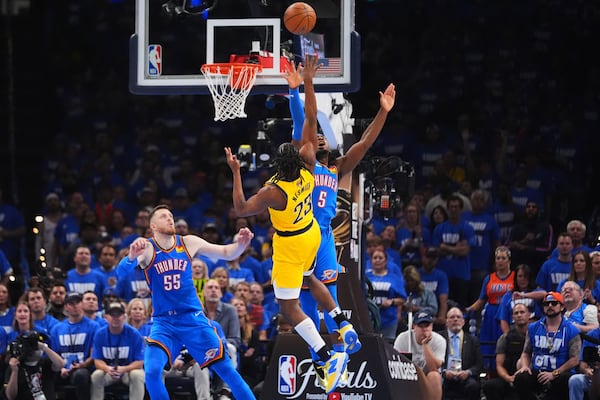 Indiana Pacers forward Aaron Nesmith (23) shoots against Oklahoma City Thunder guard Luguentz Dort (5) during the first half of Game 2 of the NBA Finals basketball series Sunday, June 8, 2025, in Oklahoma City. (AP Photo/Julio Cortez)