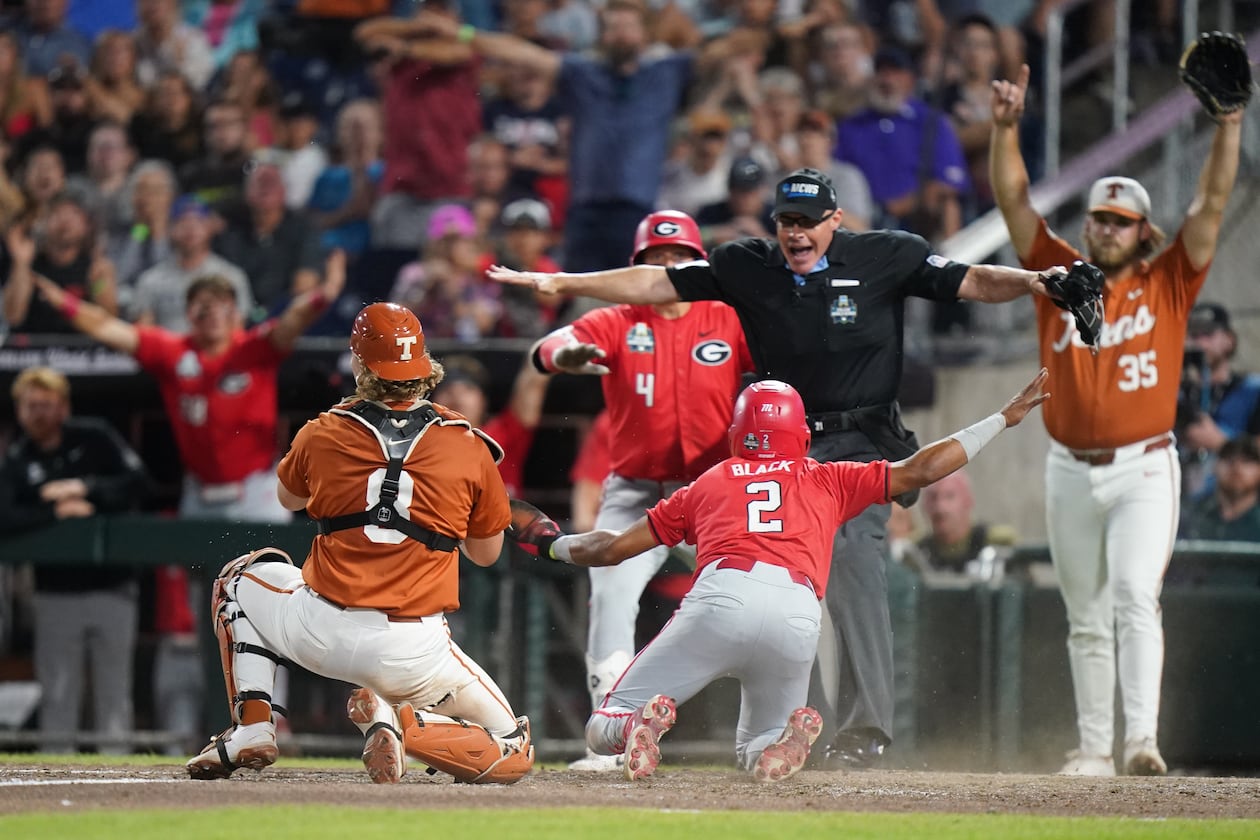 Georgia infielder Ryan Black slides safely into home and scores the second run of the game in the seventh inning during an NCAA baseball College World Series elimination game against Texas, Tuesday, June 16, 2026, in Omaha, Neb. (Vera Nieuwenhuis/AP)
