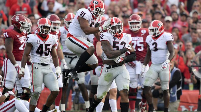 Defensive lineman Tyler Clark #52 and linebacker David Marshall #51 of the Georgia Bulldogs celebrate after a sack in the second quarter against the Oklahoma Sooners in the 2018 College Football Playoff Semifinal at the Rose Bowl on January 1, 2018 in Pasadena, California. (Photo by Kevork Djansezian/Getty Images)