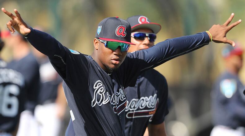 Atlanta Braves outfield prospect Ronald Acuna loosens up during spring training camp Tuesday, Feb. 20, 2018, in Lake Buena Vista, Fla.