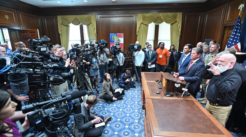 Gov. Brian Kemp speaks as other officials standing behind during a press conference to provide an update on the state’s efforts regarding COVID-19, after reporting the first death in Georgia related to coronavirus, at the Georgia State Capitol on Thursday, March 11, 2020. (Hyosub Shin / Hyosub.Shin@ajc.com)