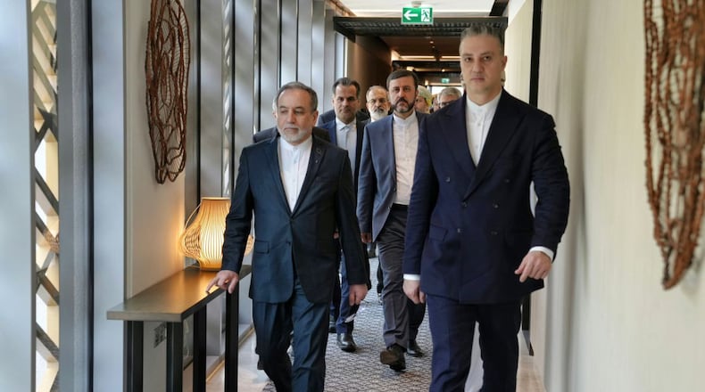In this photo released by the Iranian Foreign Ministry, Iranian Foreign Minister Abbas Araghchi, left, heads to venue for talks between Iran and the U.S., in Muscat, Oman, Friday, Feb. 6, 2026. (Iranian Foreign Ministry via AP)