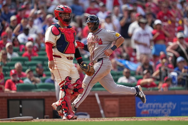 Atlanta Braves' Nacho Alvarez Jr., right, scores past St. Louis Cardinals catcher Yohel Pozo during the ninth inning of a baseball game Saturday, July 12, 2025, in St. Louis. (AP Photo/Jeff Roberson)