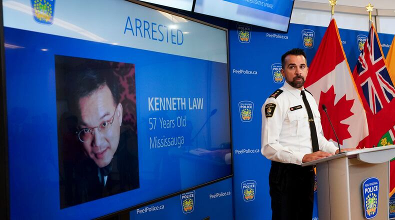 FILE - York Regional Police Inspector Simon James speaks during a news conference in Mississauga, Ontario, Aug. 29, 2023, with the image of Kenneth Law, a Canadian man accused of selling lethal substances on the internet to people at risk of self harm, displayed on screen. (Arlyn McAdorey/The Canadian Press via AP, File)