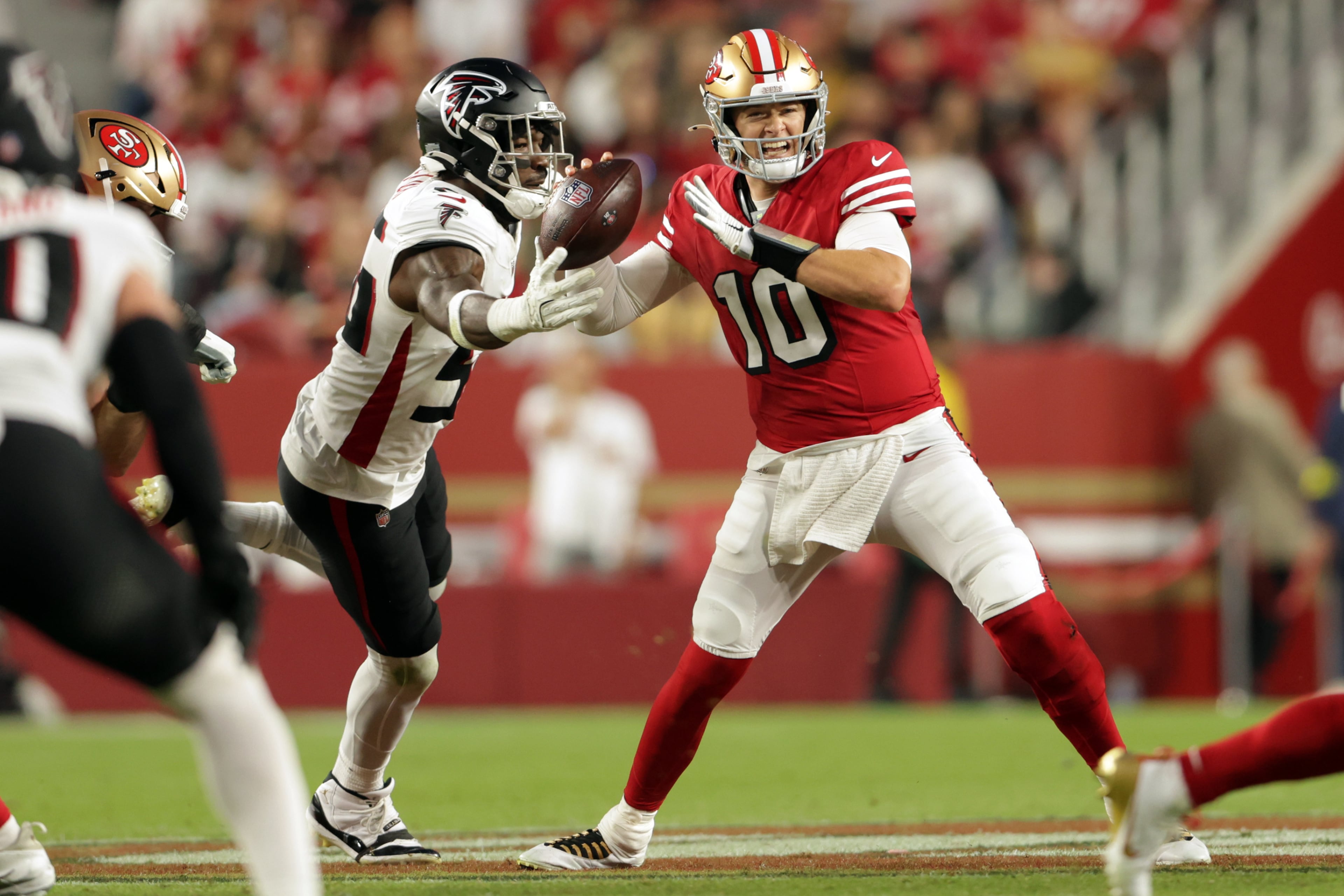 San Francisco 49ers quarterback Mac Jones (right) is pressured by Atlanta Falcons linebacker Leonard Floyd during the second quarter on Sunday, Oct. 19, 2025, in Santa Clara, Calif. (Scott Strazzantez/San Francisco Chronicle via AP)