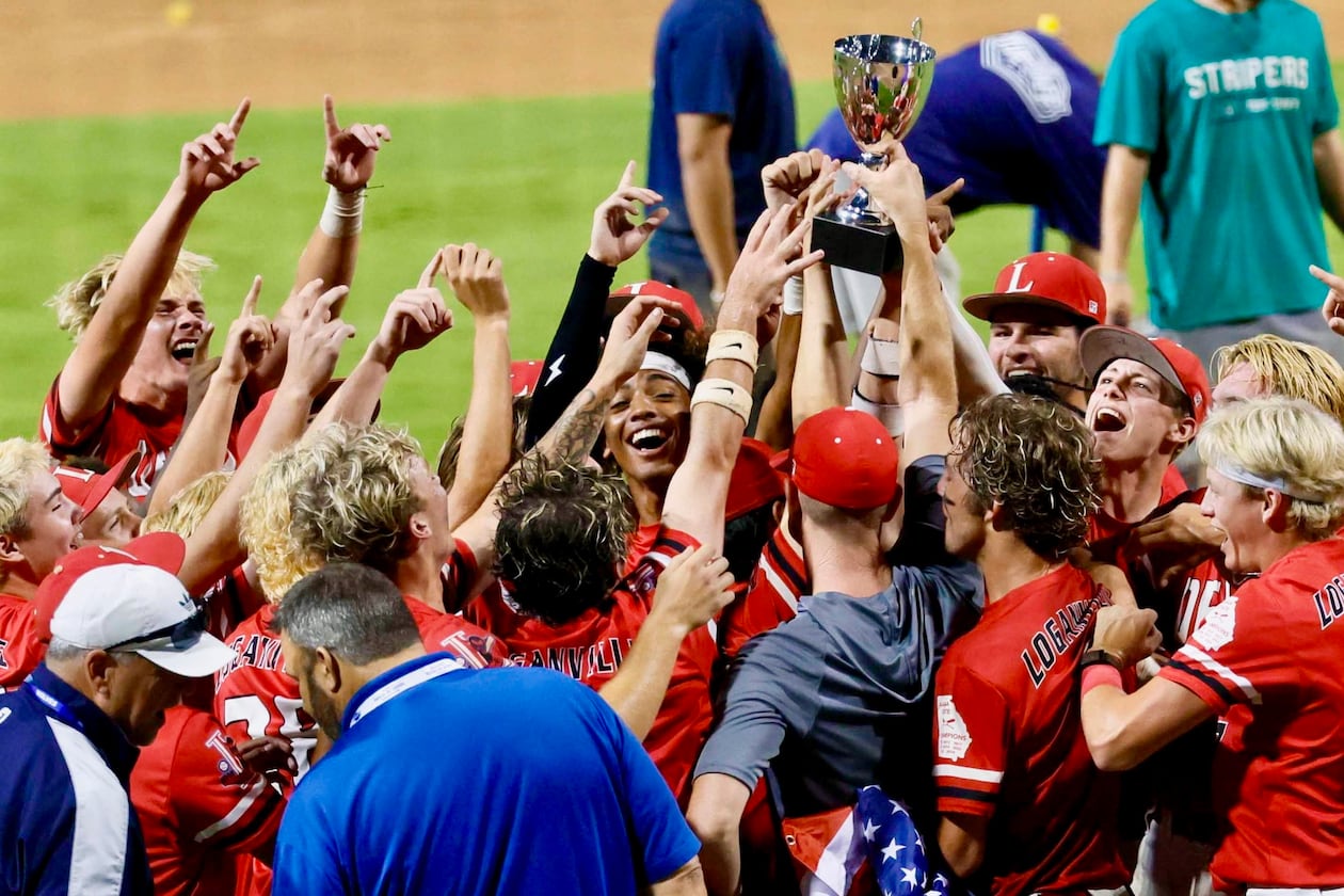 Loganville players and coaches celebrate with the trophy after winning 4-3 against Pope in Game 3 of the Class 5A GHSA Baseball State Championship Series at Gwinnett Field on Tuesday, May 26, 2026, in Lawrenceville. (Miguel Martinez/AJC)
