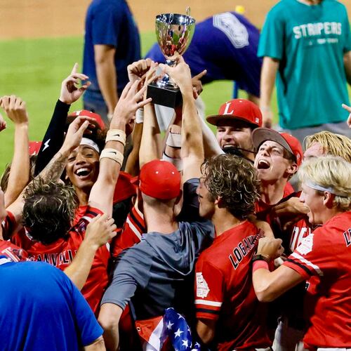 Loganville players and coaches celebrate with the trophy after winning 4-3 against Pope in Game 3 of the Class 5A GHSA Baseball State Championship Series at Gwinnett Field on Tuesday, May 26, 2026, in Lawrenceville. (Miguel Martinez/AJC)