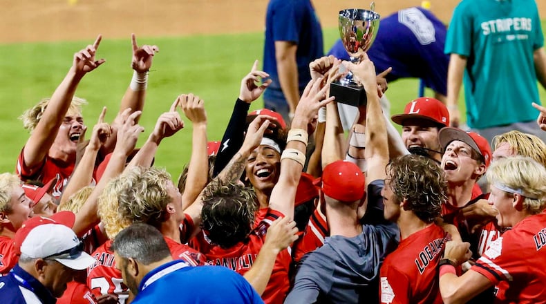 Loganville players and coaches celebrate with the trophy after winning 4-3 against Pope in Game 3 of the Class 5A GHSA Baseball State Championship Series at Gwinnett Field on Tuesday, May 26, 2026, in Lawrenceville. (Miguel Martinez/AJC)