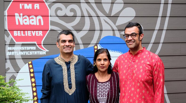 Poonam Idnani (center) visits sons Samir (left) and Neal (right) at their NaanStop location in Atlantic Station for tasting and quality control of her signature recipes. (Courtesy of Brandon Amato)