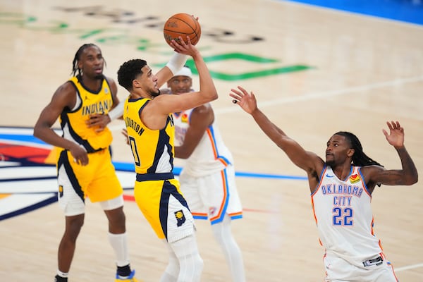Indiana Pacers guard Tyrese Haliburton (0) shoots a 3-pointer against Oklahoma City Thunder guard Cason Wallace (22) during the second half of Game 1 of the NBA Finals basketball series Thursday, June 5, 2025, in Oklahoma City. (AP Photo/Julio Cortez)