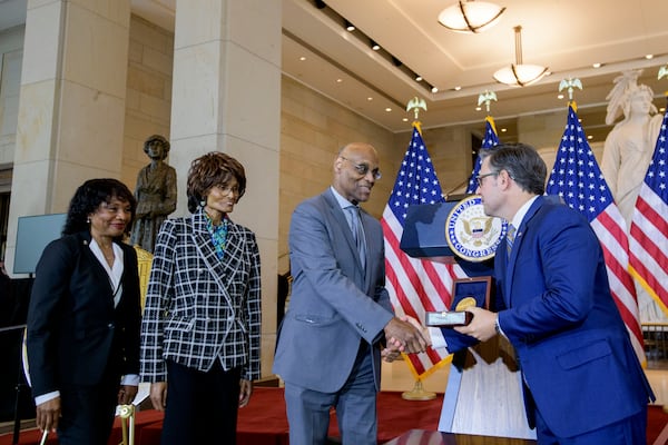House Speaker Mike Johnson, R-La., right, presents the Congressional Gold Medal to Stanley Earley III, son of Lt. Col. Charity Adams Earley, second from right, as Judith Earley, second from left, and retired Amy Col. Edna W. Cummings, left, watch during a ceremony honoring the Six Triple Eight, on Capitol Hill, Tuesday, April 29, 2025, in Washington. (AP Photo/Rod Lamkey, Jr.)