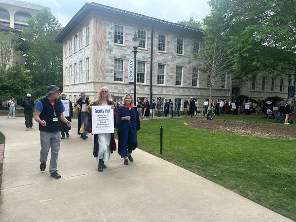 Emory University Professor Pamela Scully (center) and Professor Noëlle McAfee (right) lead a procession of faculty protesting for academic freedom on campus on Wednesday, April 23, 2025. Photo contributed by Mike Winkler