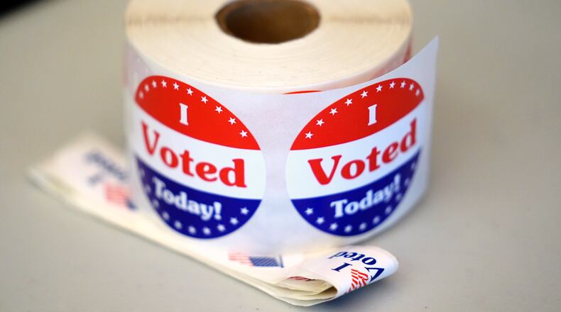 FILE - A spool of stickers rests on a table at a polling station during Massachusetts state primary voting, Sept. 3, 2024, at the Newton Free Library, in Newton, Mass. (AP Photo/Steven Senne, File)