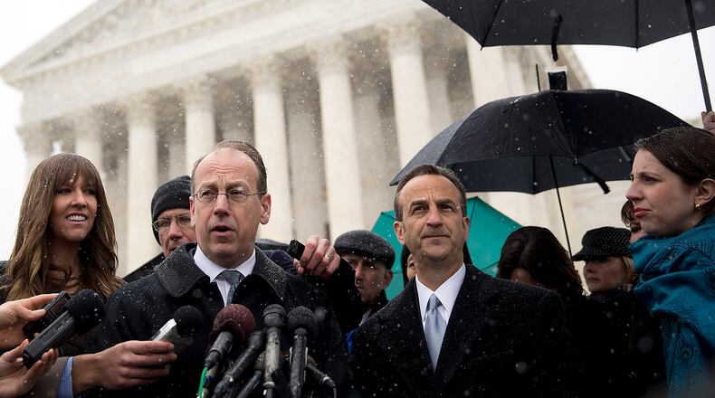 Paul Clement, lawyer arguing before the U.S. Supreme Court on behalf of Hobby Lobby Stores Inc. and Conestoga Wood Specialties Corp., center, speaks to the media with David Cortman, senior counsel and vice-president of religious liberty with Alliance Defending Freedom, right, following arguments in Washington, D.C., U.S., on Tuesday, March 25, 2014. A divided U.S. Supreme Court debated whether companies can assert religious rights, hearing arguments in an ideological clash over President Barack Obama's health care law and rules that promote contraceptive coverage.