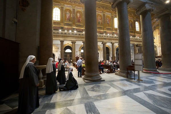Nuns prays during a mass in Santa Maria in Trastevere church, in central Rome, Sunday, May 4, 2025. (AP Photo/Alessandra Tarantino)