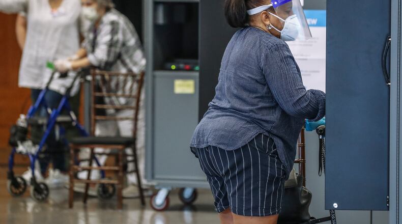 Voters at the machines on Tuesday, Aug. 11, 2020 at Magnolia Hall located at 1320 Monroe Drive NE in Atlanta. JOHN SPINK/JSPINK@AJC.COM